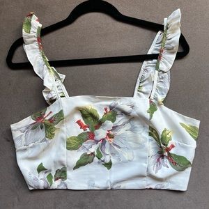 Hawaiian print crop top with ruffle sleeves and zipper detail.